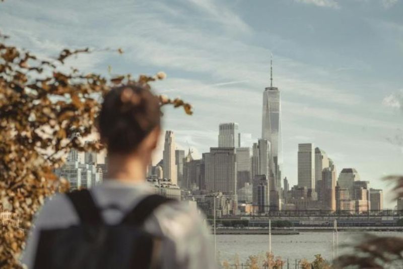 male looking at a view of a building